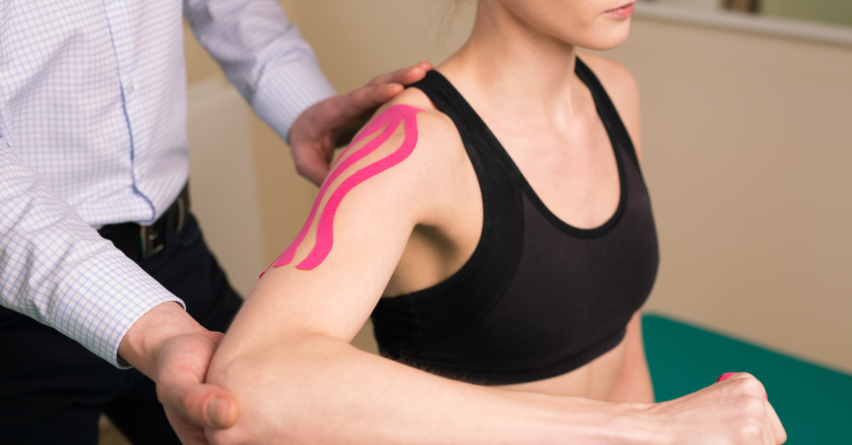 Sports medicine physician treating a woman with shoulder pain
