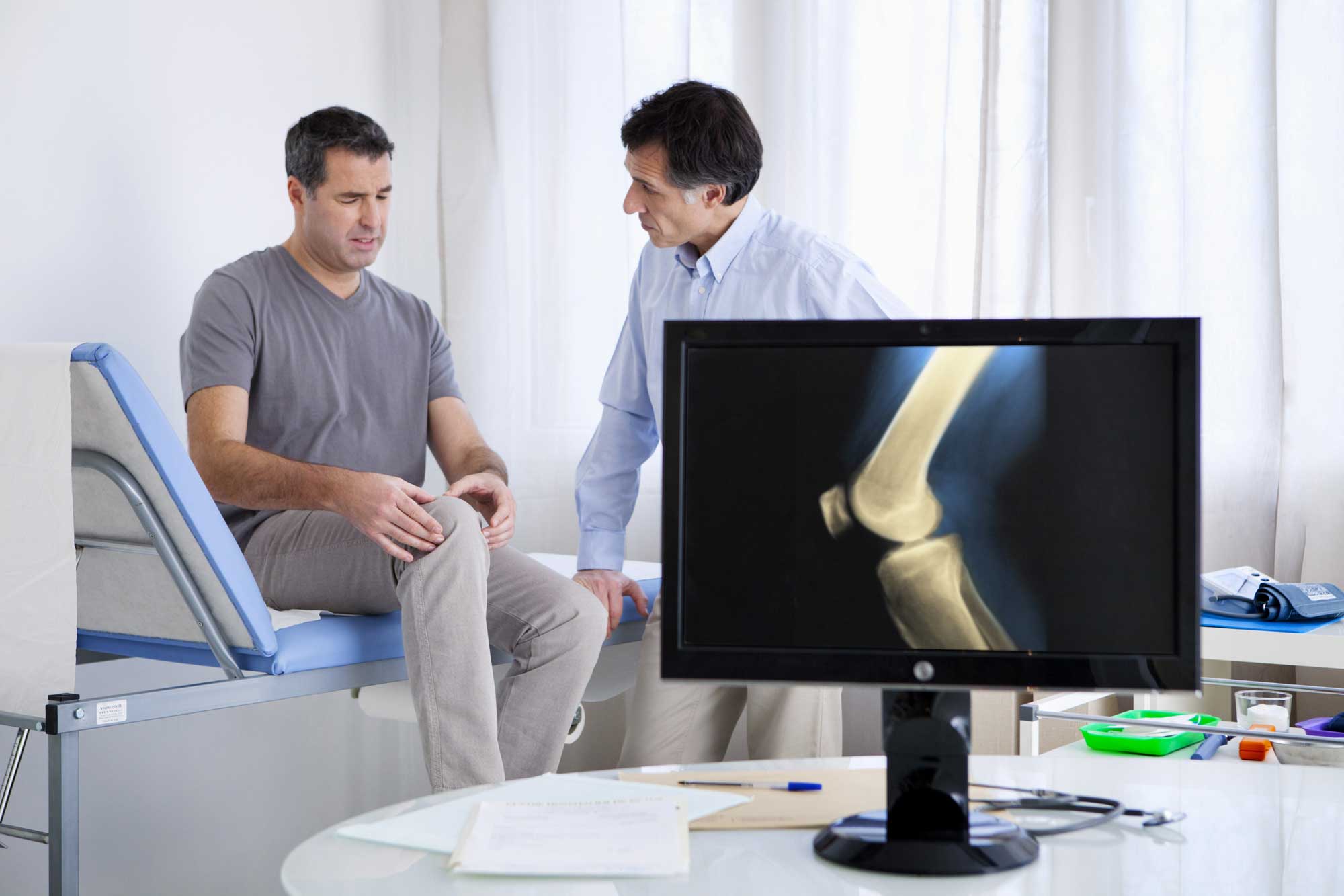 Doctor and patient addressing a knee injury