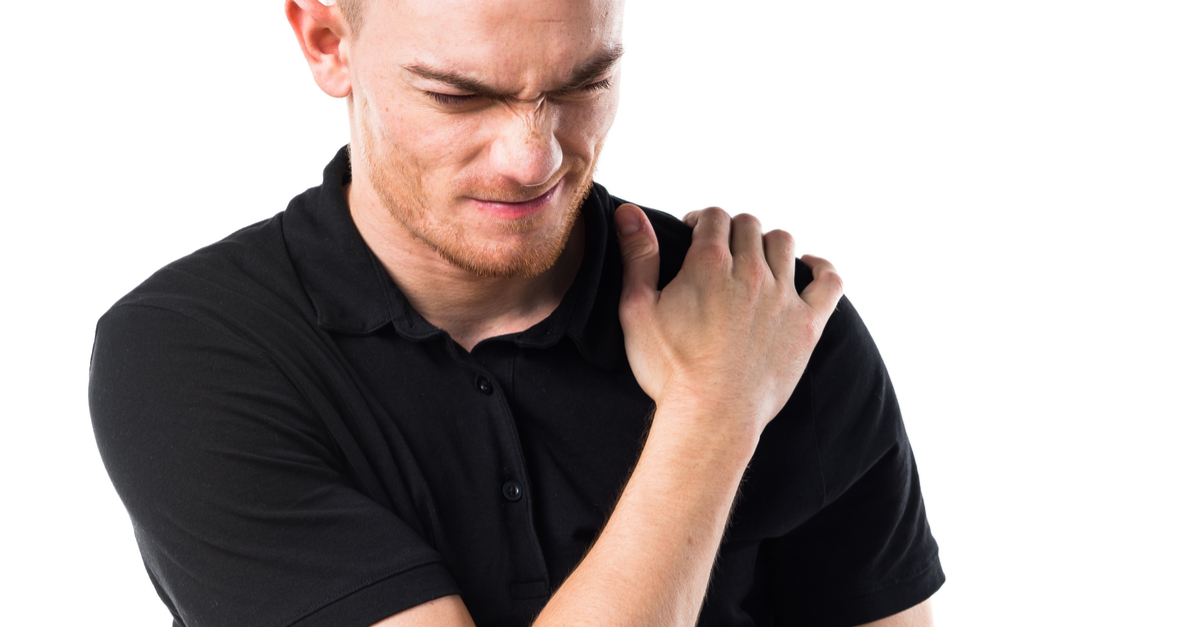 Man massaging his torn shoulder