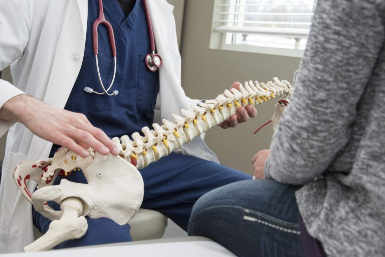 An orthopedic doctor explaining the spine to a patient