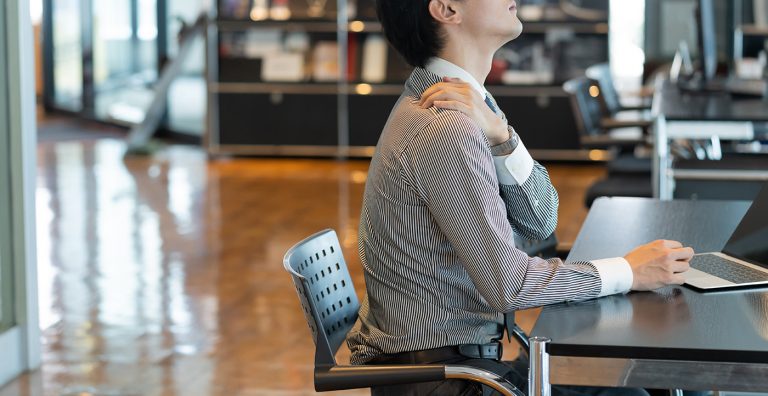 Man sitting at his computer with neck pain