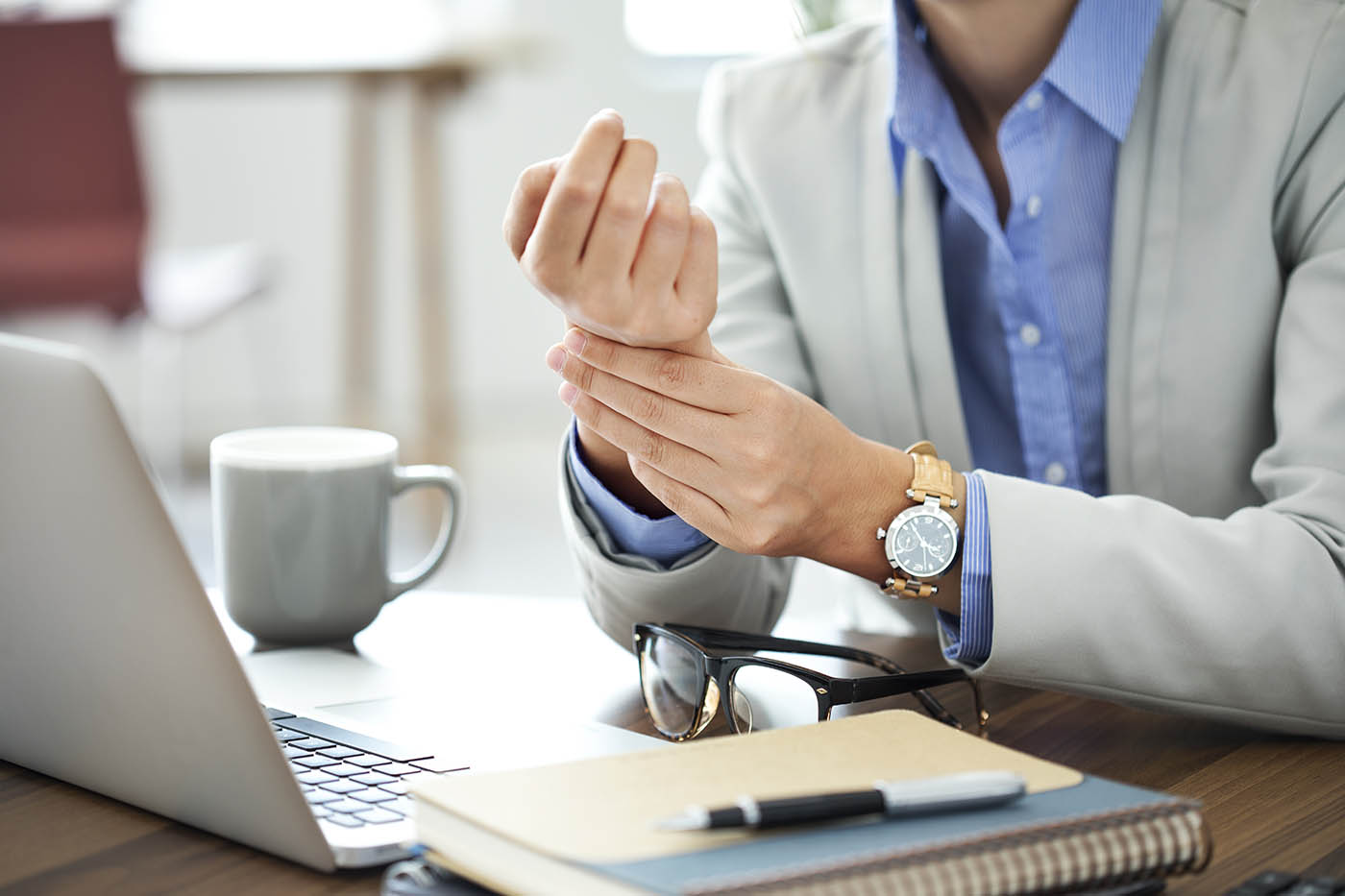 Woman holding her wrist with Carpal Tunnel pain