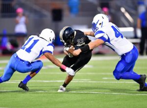 Man getting tackled in football